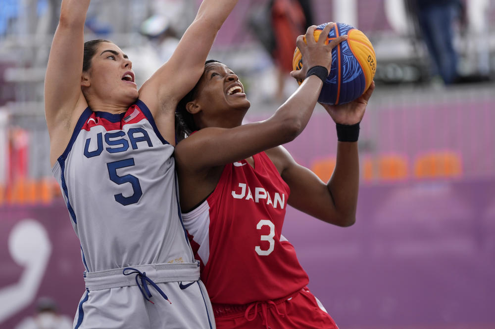 Japan's Stephanie Mawuli heads to the basket past U.S. player Kelsey Plum during a women's 3 x 3 basketball game at the Summer Olympics on Tuesday.
