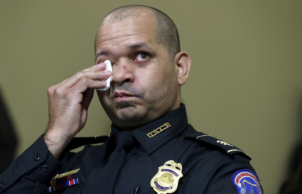 U.S. Capitol Police officer Aquilino Gonell wipes his eyes as he watches a video being displayed during a House select committee hearing on Tuesday.