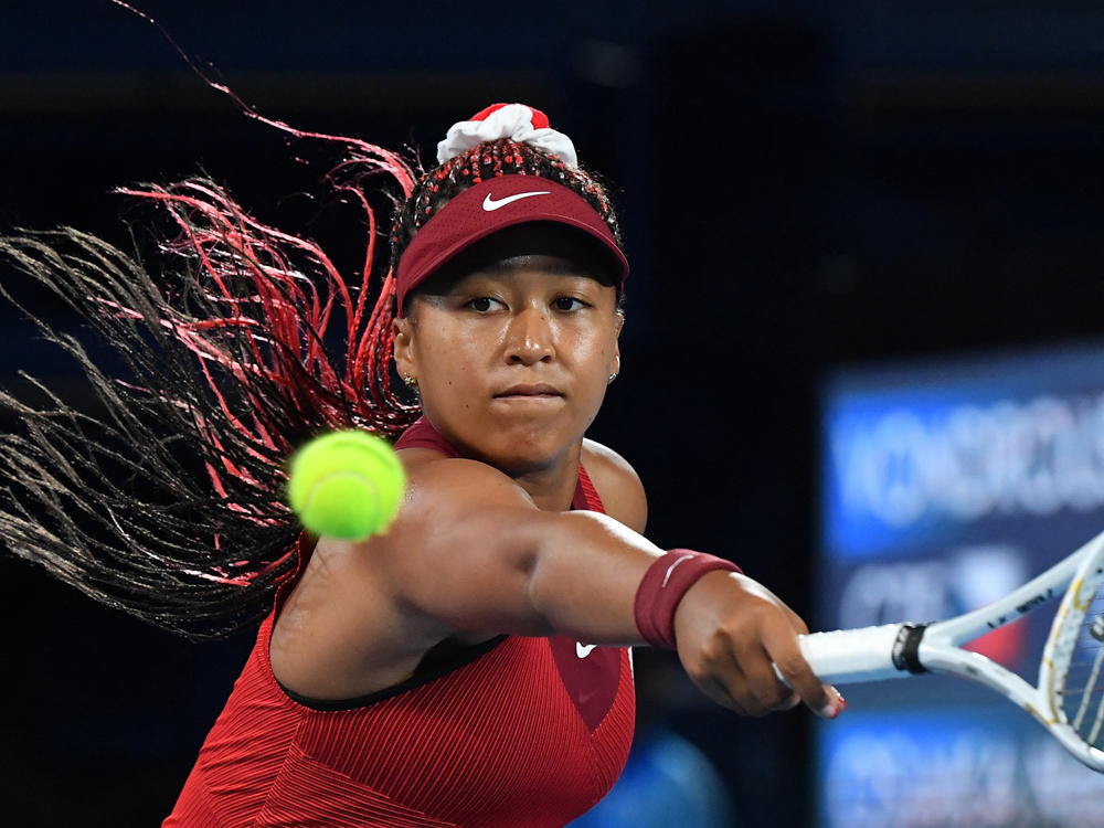 Japan's Naomi Osaka returns the ball to the Czech Republic's Marketa Vondrousova during their third round tennis match at the Tokyo Games on Tuesday.