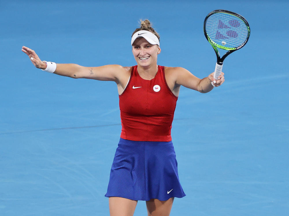 Marketa Vondrousova of Team Czech Republic celebrates after beating Japan's Naomi Osaka in straight sets of the third round at the Olympics.