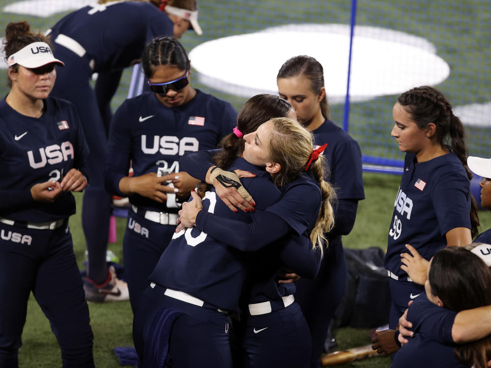 Haylie McCleney #8 hugs Catherine Osterman #38 of Team United States after losing to Team Japan 2-0 in the Softball Gold Medal Game on day four of the Tokyo 2020 Olympic Games.