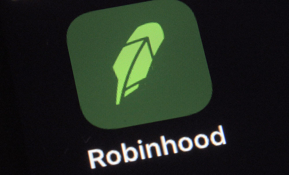 A Dec. 17, 2020 photo shows the logo for the stock trading Robinhood app on a smartphone in New York. Robinhood will make its debut on the Nasdaq on Thursday, just as state and federal regulators continue probes into the company.