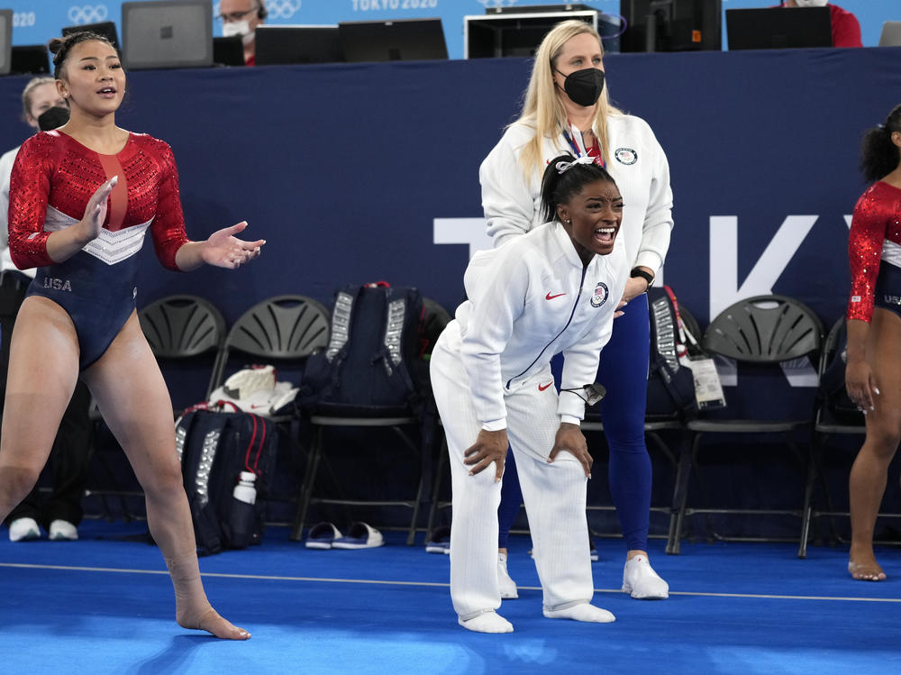 Simone Biles (center) cheers the performance of teammate Grace McCallum after she withdrew from the artistic gymnastics women's final at the Summer Olympics on Tuesday in Tokyo.