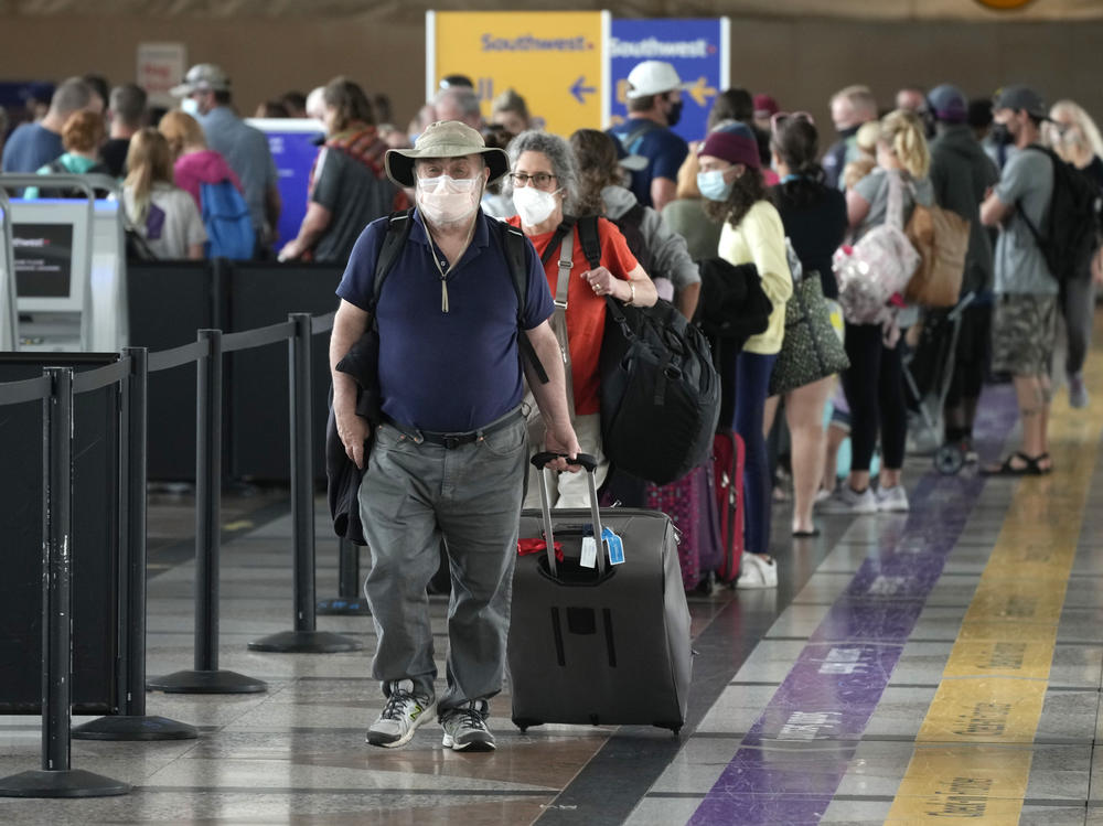 Travelers head to a security checkpoint at Denver International Airport on July 2. The economy likely surged in the April-June quarter as vaccine rollouts sparked a surge in pent-up activity. A slowdown is now seen as inevitable, although the pace of growth should remain strong.