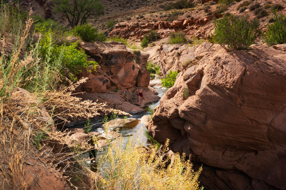 Tourists frequent swimming holes along a federal Bureau of Land Management trail east of Moab.