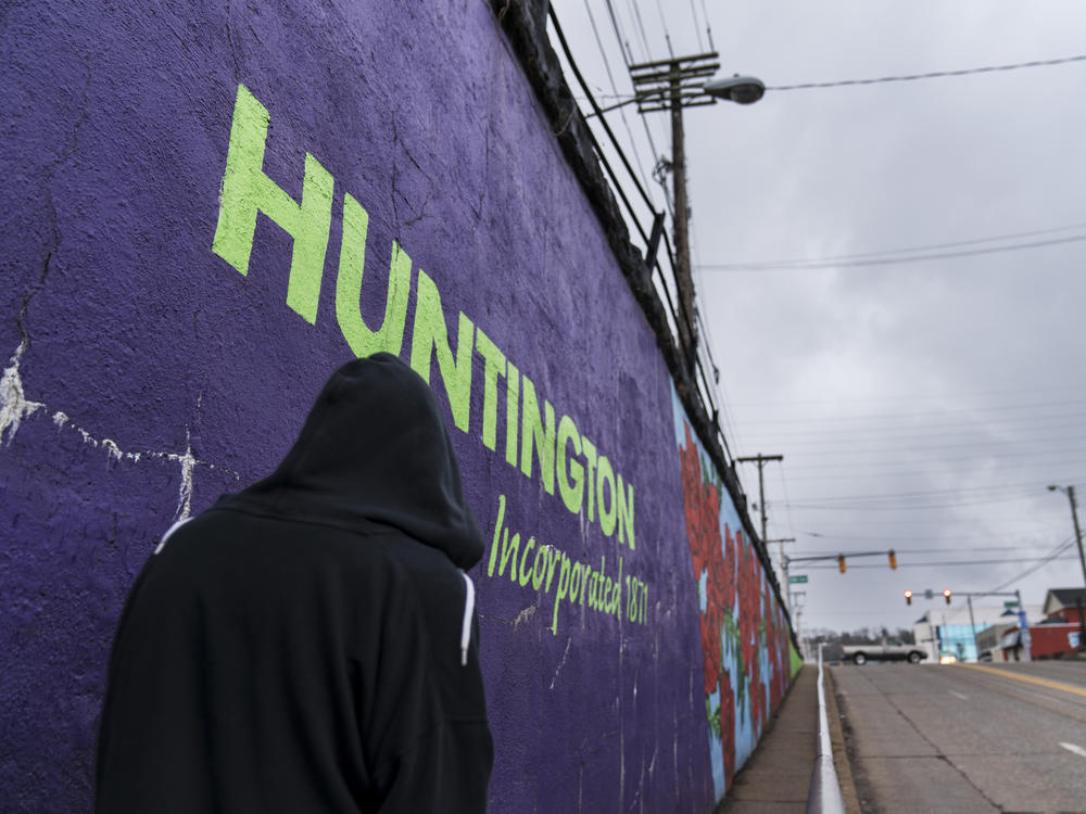 A pedestrian walks past a mural in Huntington, W.Va., on March 18. Huntington was once ground zero for the U.S. opioid epidemic.