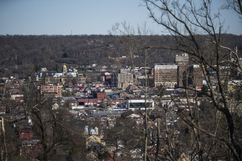 Downtown Huntington, W.Va., is seen through the trees on March 19. Other communities are watching the trial in West Virginia as they build their own legal cases against drug companies.