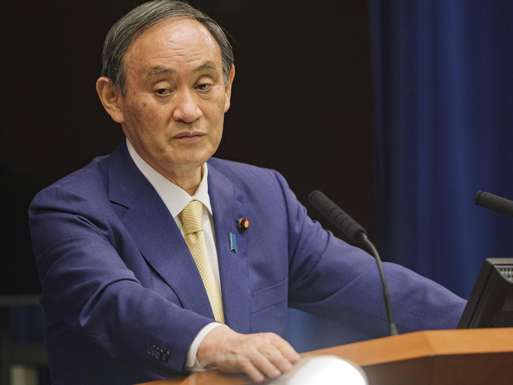 Japanese Prime Minister Yoshihide Suga will extend a state of emergency to four more prefectures due to rising coronavirus infections. Here, Suga addresses a news conference on July 8.