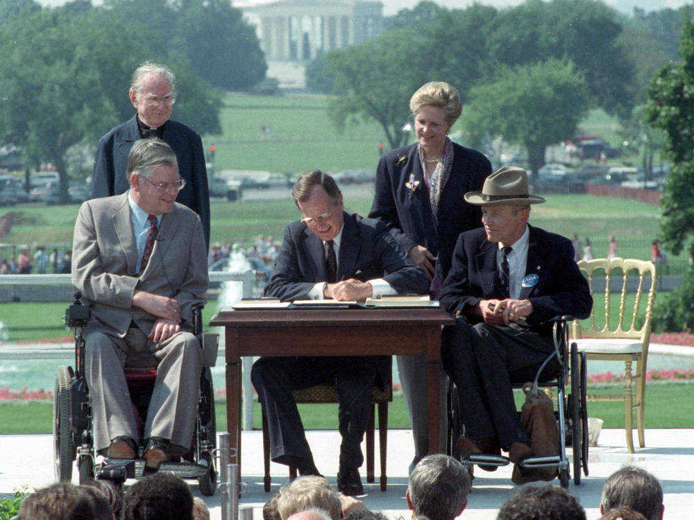 President George H. W. Bush signs the Americans with Disabilities Act on July 26, 1990.