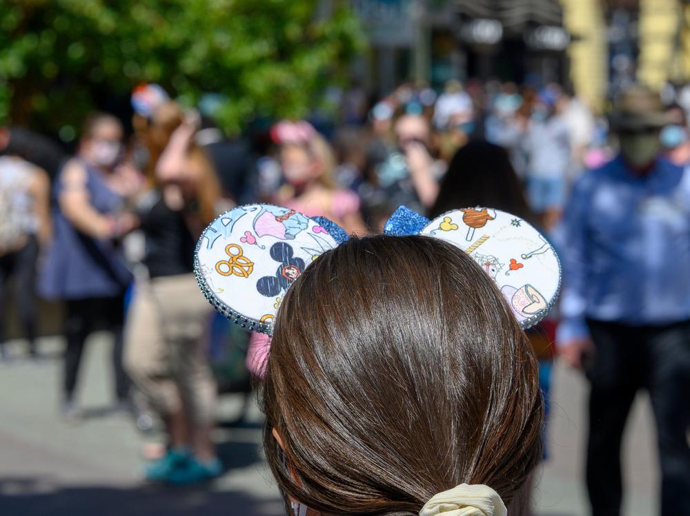 People visit Downtown Disney in Anaheim, California on July 9, 2020, the first day the outdoor shopping and dining complex was open to the public since closing in March amid the onset of the COVID-19 pandemic.