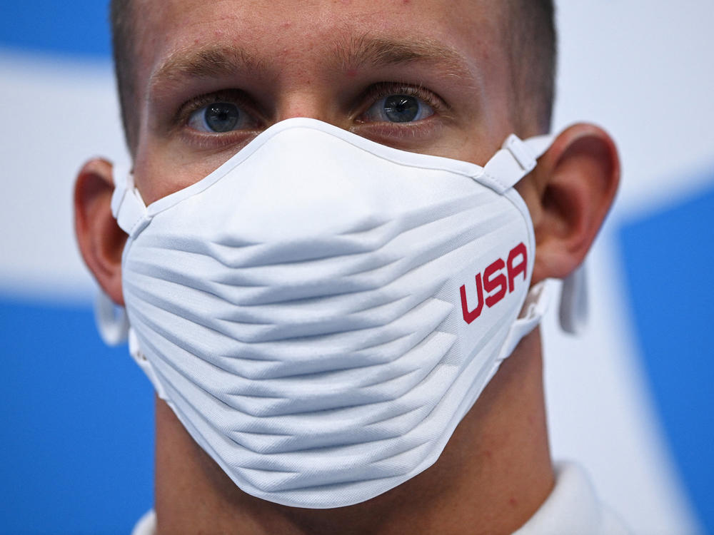 Team USA's Caeleb Dressel wears a USA-branded face covering while waiting to receive his gold medal after the final of the men's 4x100 meter freestyle relay swimming event during the Tokyo Olympics at the Tokyo Aquatics Centre on Monday.