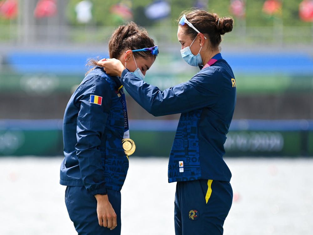 Gold medalists Ancuta Bodnar and Simona Radis of Romania celebrate on the podium following the women's double sculls final at the Tokyo Olympics on Wednesday.