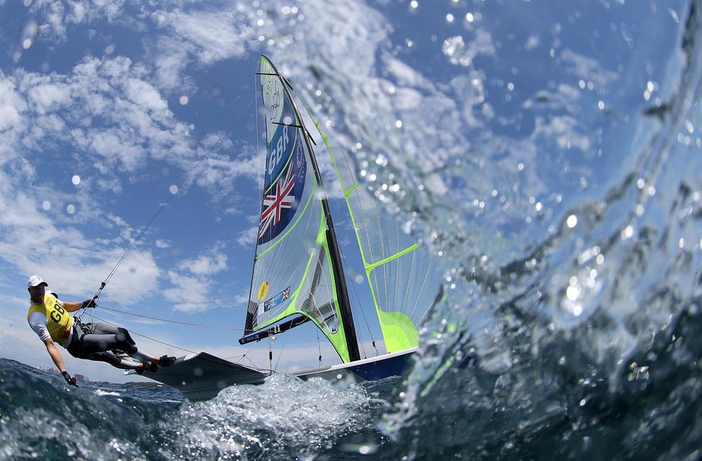 Dylan Fletcher and Stuart Bithell of Team Great Britain head out onto the water to compete in the Men's Skiff 49er class on July 29, 2021.