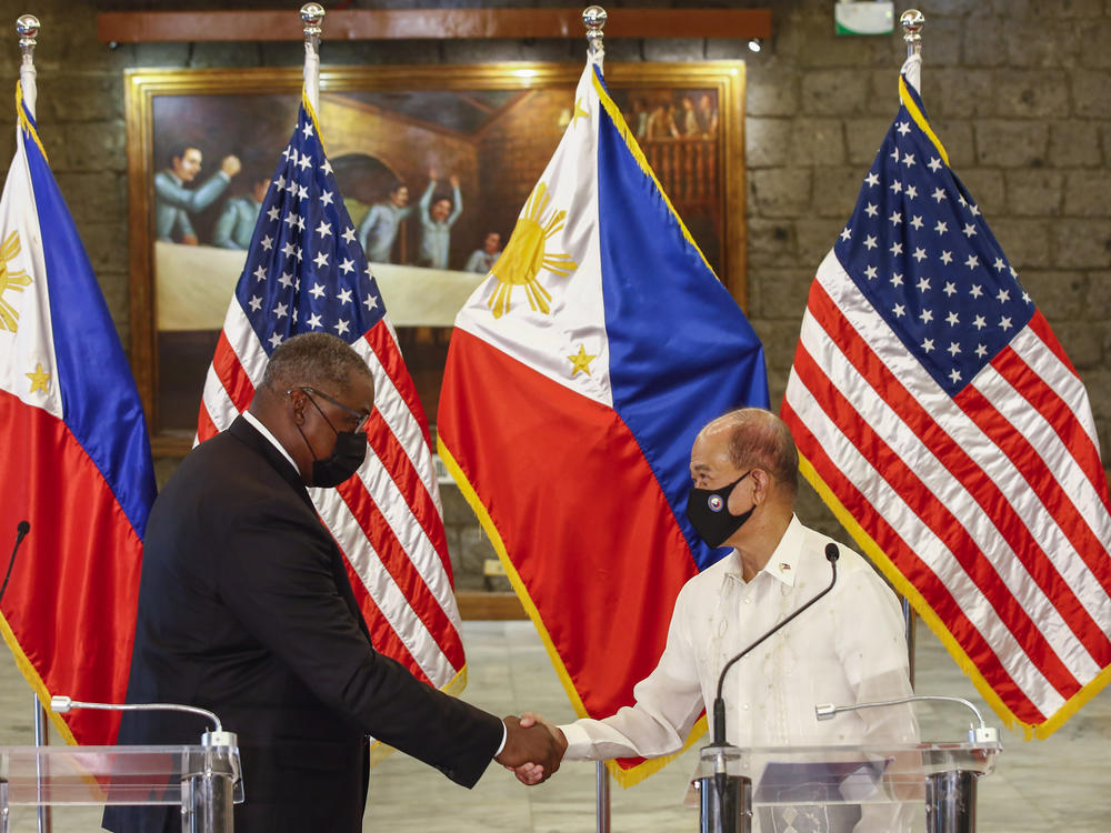 U.S. Defense Secretary Lloyd Austin, left, and Philippines Defense Secretary Delfin Lorenzana shake hands after a bilateral meeting at Camp Aguinaldo military camp in Quezon City, Metro Manila, Philippines Friday, July 30. Austin is visiting Manila to hold talks with Philippine officials to boost defense ties and possibly discuss the The Visiting Forces Agreement between the US and Philippines.