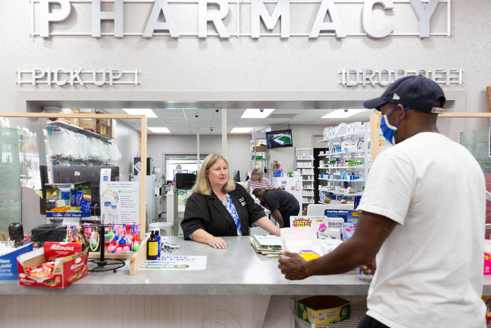 Pharmacist Cheryl Stimson checks in Michael Haynes, who came to the Dumas Family Pharmacy for his first vaccine shot on July 27. Stimson has given more than 5,800 vaccines since the start of the pandemic.
