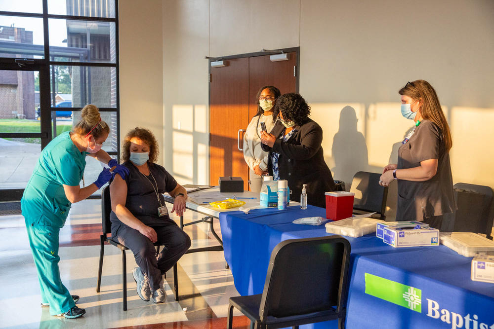 Health care worker Levinna Myers decided to get her first shot during a town hall meeting about COVID-19 vaccines on July 28 in Heber Springs, Ark.