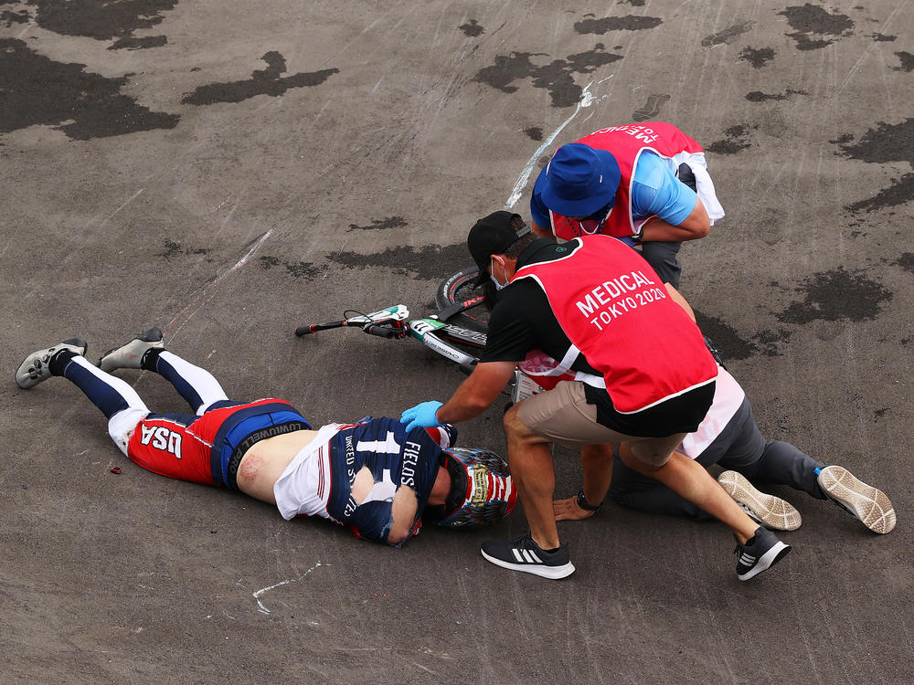 U.S. BMX racer Connor Fields receives medical treatment after a crash during a men's BMX semifinal heat at the Ariake Urban Sports Park in Tokyo.