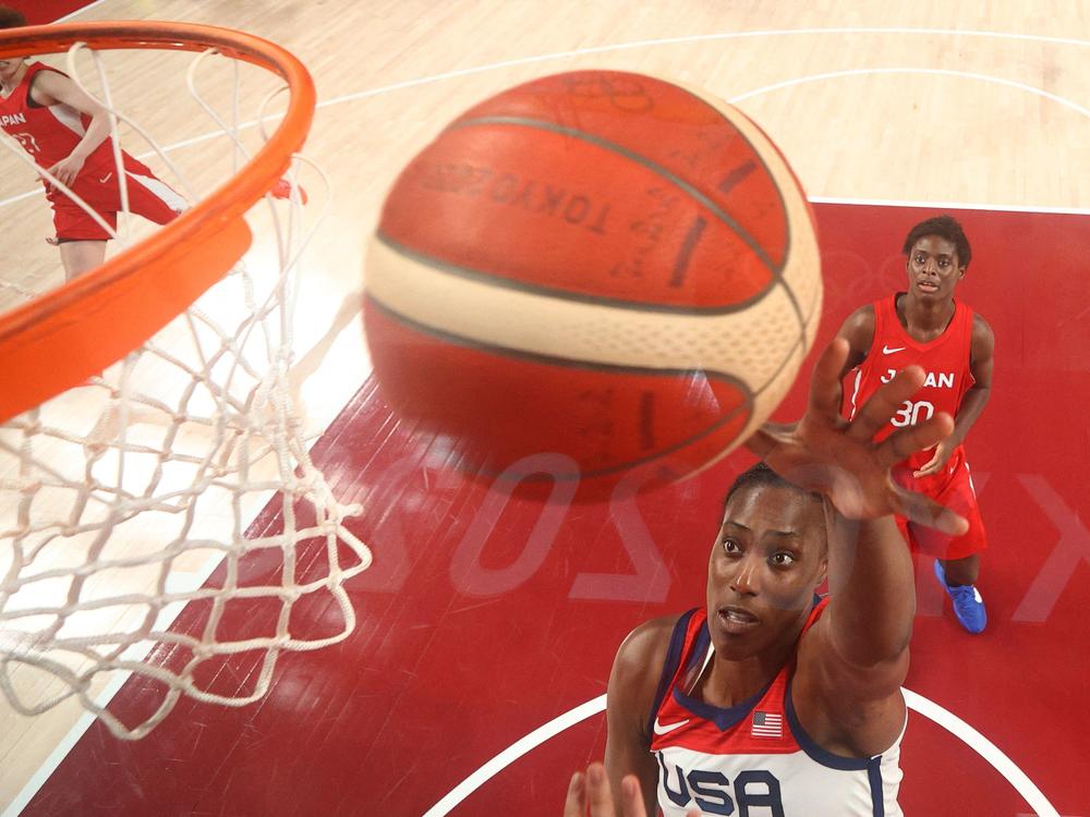 USA's Sylvia Fowles goes to the basket past Japan's Evelyn Mawuli (R) in the women's preliminary round between Japan and USA during the Tokyo 2020 Olympic Games on Friday.