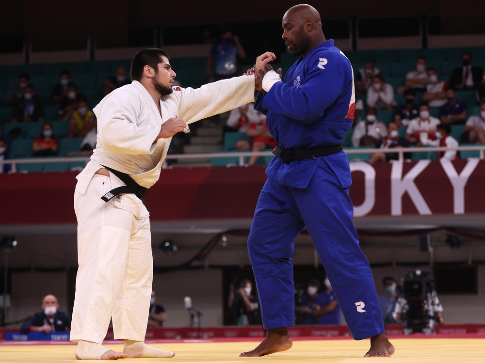 France's Teddy Riner (right) and Tamerlan Bashaev of the team from Russia compete Friday during the men's judo over 100-kilogram quarterfinal at the Tokyo Olympics.