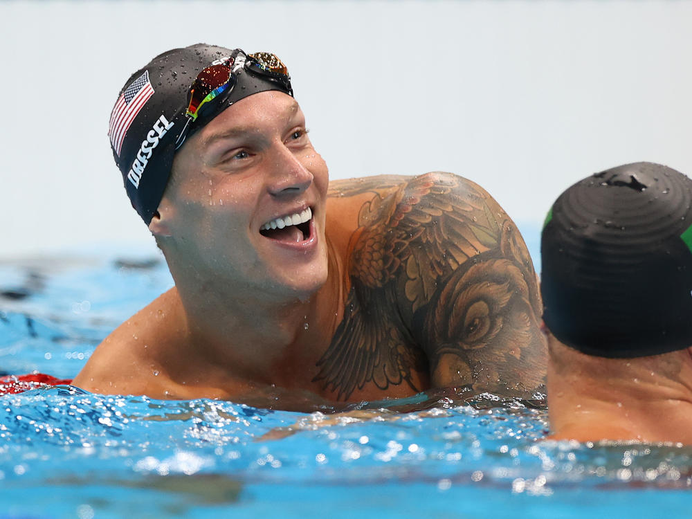 U.S. star Caeleb Dressel reacts after winning the gold medal and breaking the Olympic record in the men's 50 meter freestyle final at the Tokyo Olympics.