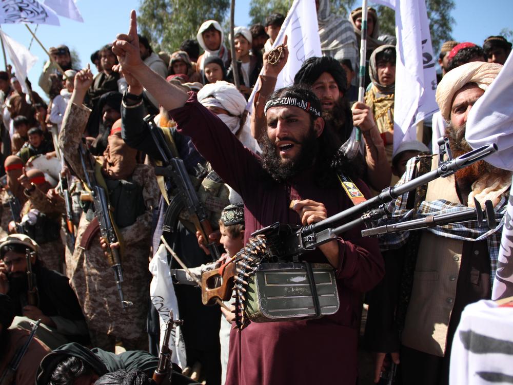 Afghan Taliban fighters and villagers attend a gathering in Laghman province, Alingar district, in March 2020 as they celebrate the peace deal signed between the U.S. and the Taliban.