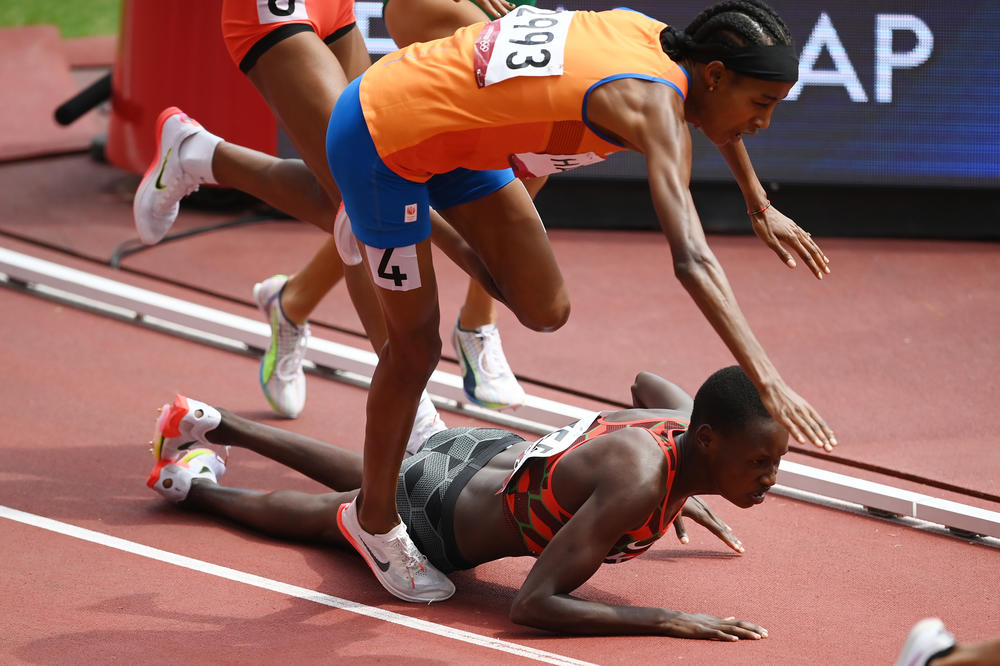Sifan Hassan of The Netherlands and Edinah Jebitok of Kenya trip and fall during their 1,500 meter heat on Monday.