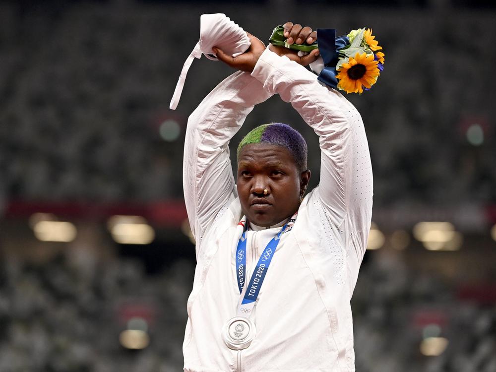 Team USA's Raven Saunders gestures on the podium with her silver medal after competing in the women's shot put event Sunday at the Tokyo Olympics.