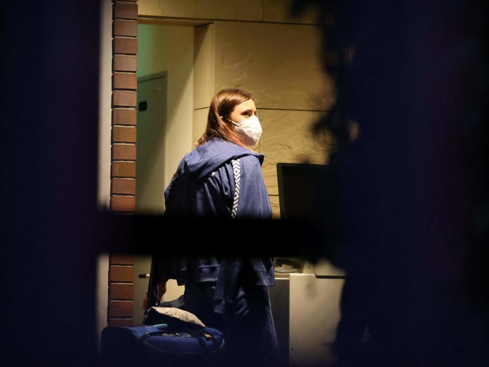 Belarus athlete Kristina Timanovskaya, who claimed her team tried to force her to leave Japan following a row during the Tokyo 2020 Olympic Games, walks with her luggage inside the Polish embassy in Tokyo on August 2, 2021.