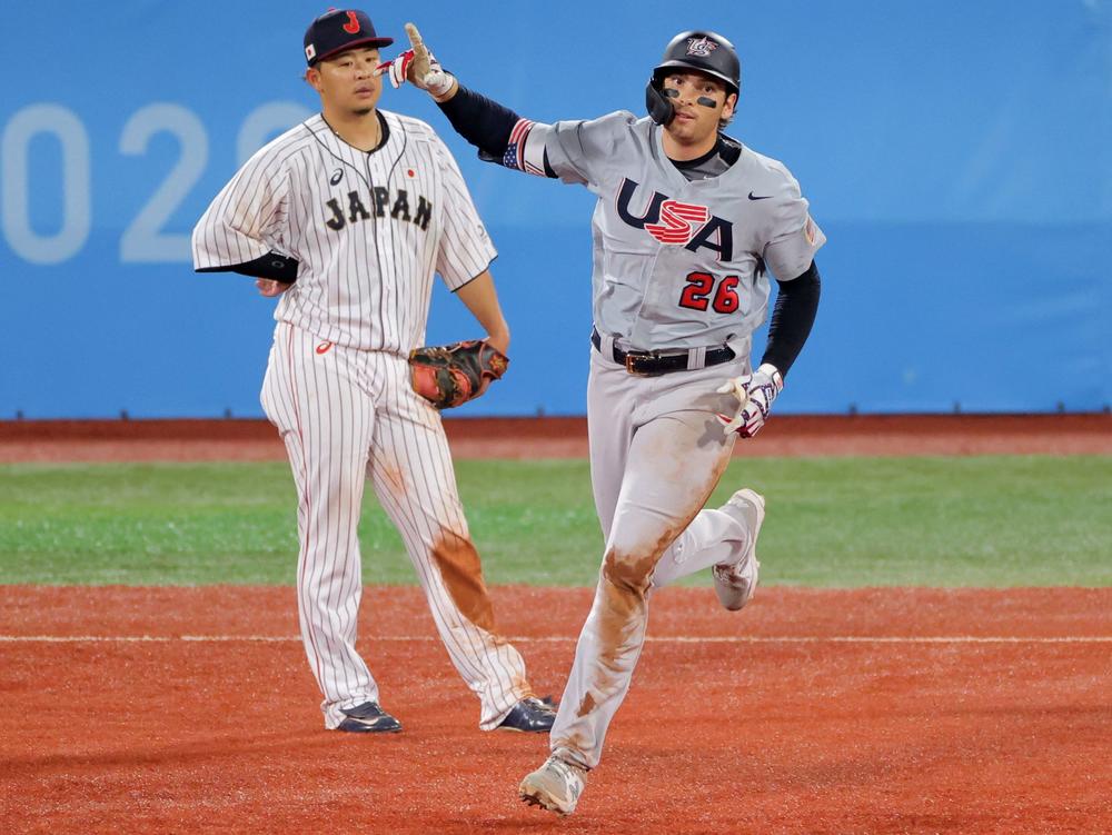Team USA's Triston Casas trots the bases Monday after hitting a three-run homer against Japan as Hideto Asamura watches. Japan came back to defeat the U.S. 7-6 in extra innings at the Tokyo Olympics.