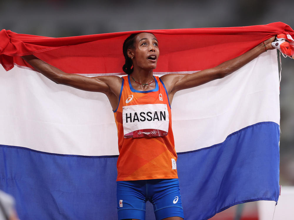 Sifan Hassan of Team Netherlands celebrates as she walks the track with her country's flag after winning the gold medal in the women's 5,000 meter final on Day 10 of the Tokyo Games.