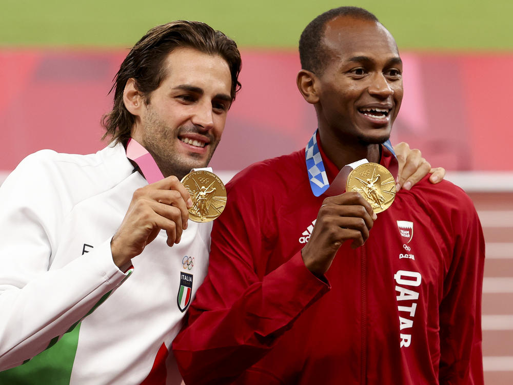 Gold medalists Gianmarco Tamberi of Italy and Mutaz Essa Barshim of Qatar shared the podium after the men's high jump at the Tokyo 2020 Olympic Games at Olympic Stadium.