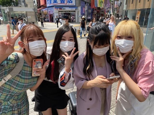 Members of a JPOP idol group perform in Tokyo's famed Shibuya street crossing. They're excited about the Olympics.