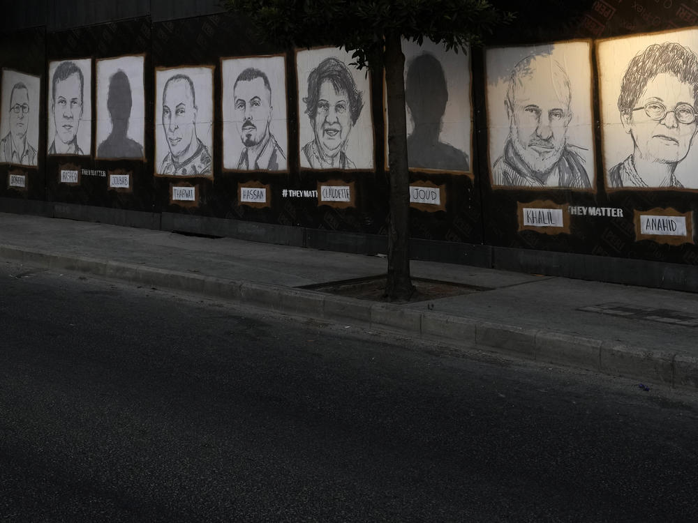 Pictures of the victims of the Aug. 4, 2020, Beirut port explosion hang on a street in Beirut.