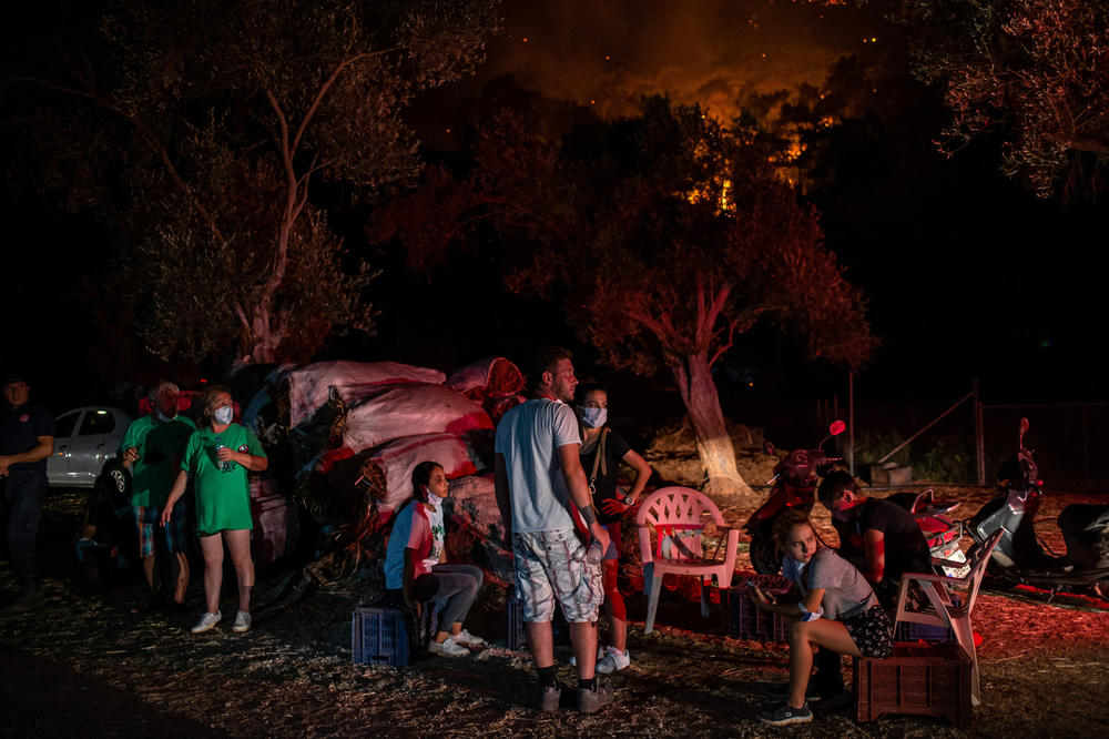 People wait near wildfires in the rural area of Marmaris, district of Mugla, on August 1.