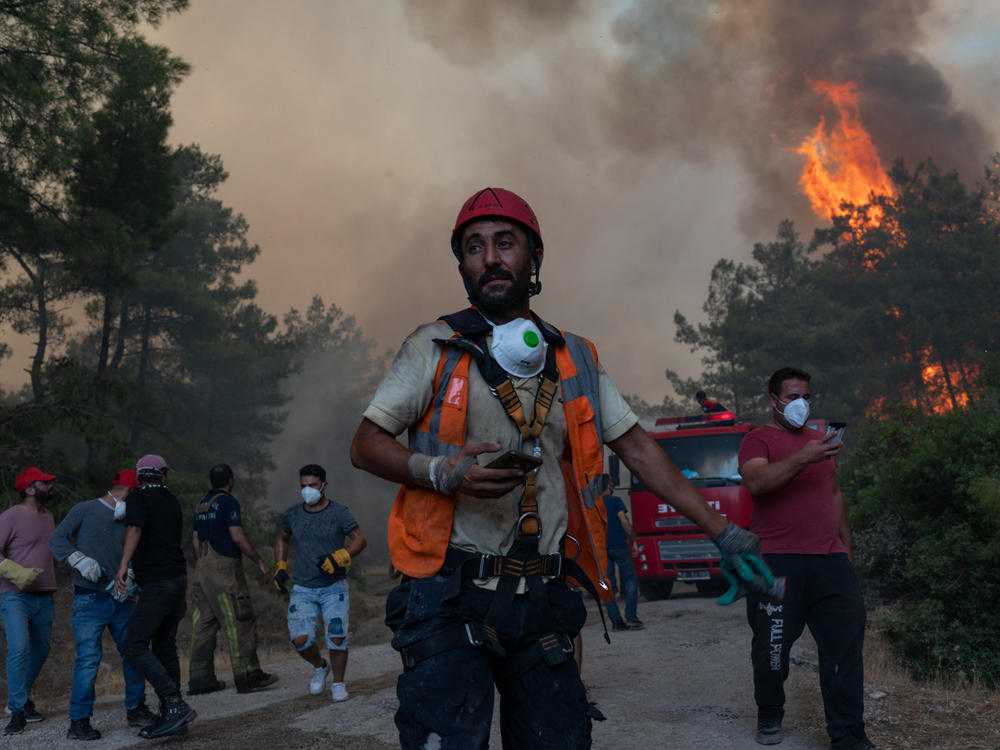 Firefighters battle a wildfire on August 2 in Mugla, Marmaris district. The European Union sent help to Turkey and volunteers joined firefighters in battling a week of violent blazes that have killed eight people.