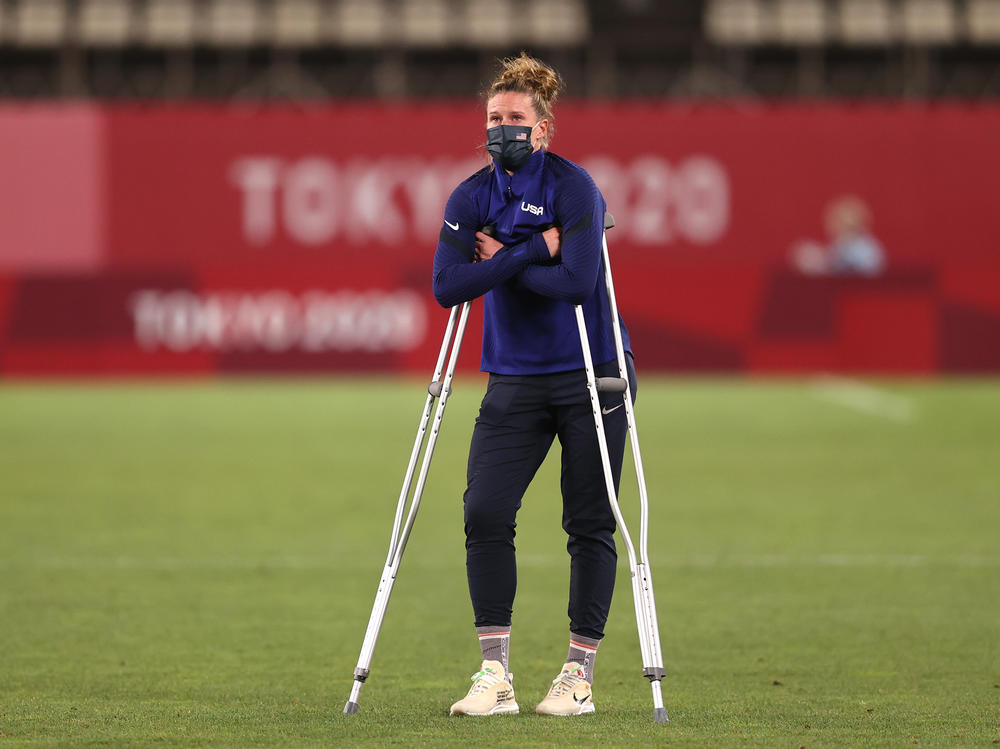 Alyssa Naeher stands with crutches following her injury after Canada defeated the U.S.