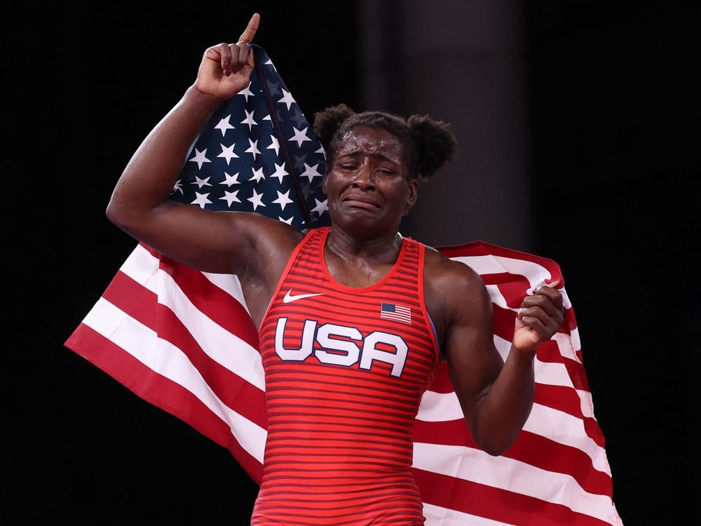 Mensah-Stock alternates between smiling and crying Tuesday as she celebrates a gold medal in her Olympic debut.