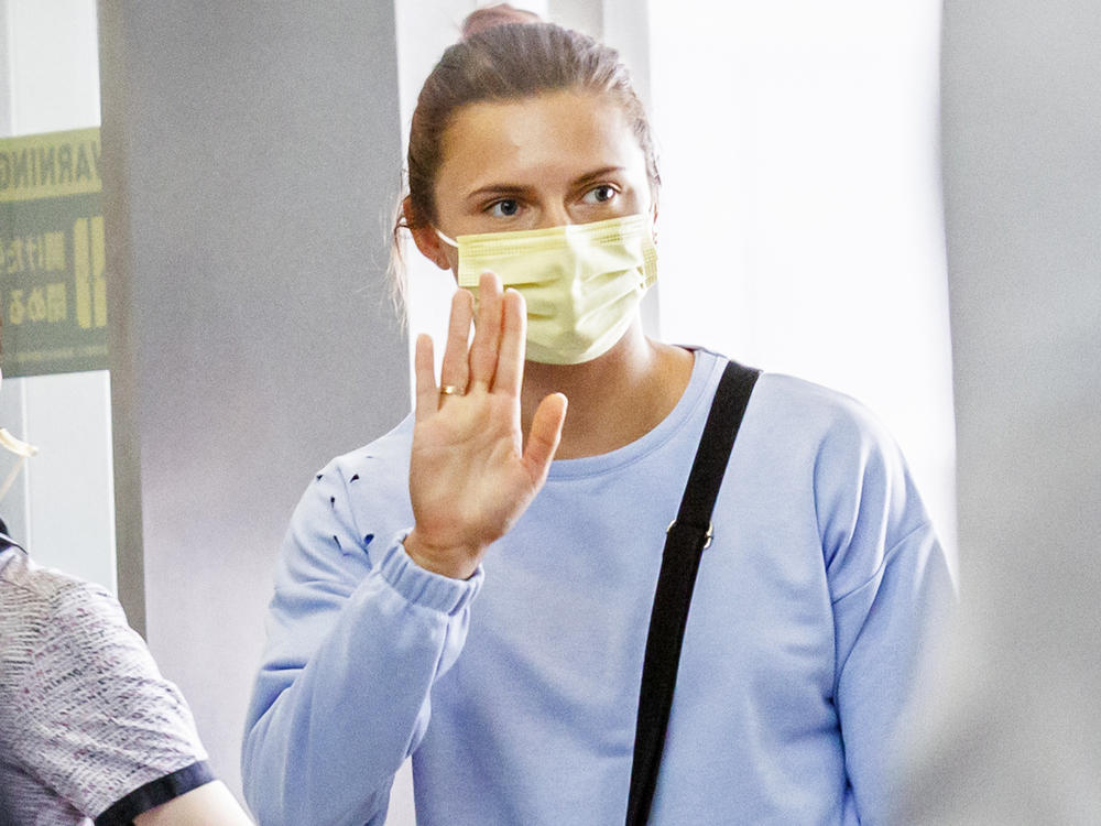 Belarusian athlete Kristina Timanovskaya received a humanitarian visa from Poland after her country's officials tried to force her to take an early flight home from the Tokyo Olympics. Here she boards a flight Wednesday to Austria at Japan's Narita international Airport.