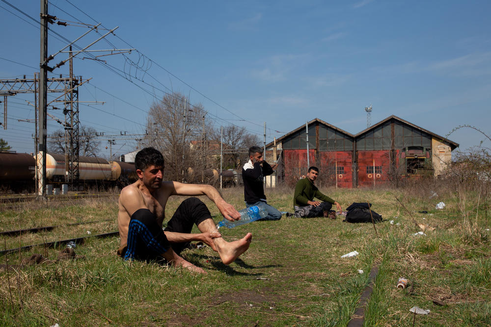 Jihan Zeb (left), from Afghanistan, and other asylum seekers found refuge in an abandoned railway station in the Serbian city of Subotica, on the border with Hungary. They say they have each tried to cross into neighboring EU countries more than 10 times — and will keep trying.