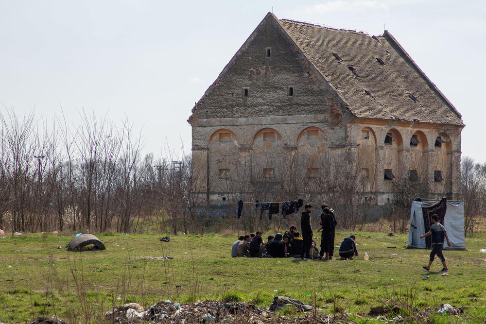 Migrants who don't stay in Serbia's state-run camps sleep in makeshift shelters, abandoned houses or in fields and forests along the borders. Asylum-seekers from Afghanistan sit in an abandoned farm field on the outskirts of the village of Horgos, a few paces away from the border with Hungary. Its proximity to the EU border has made this ruin one of the most popular squats among migrants.