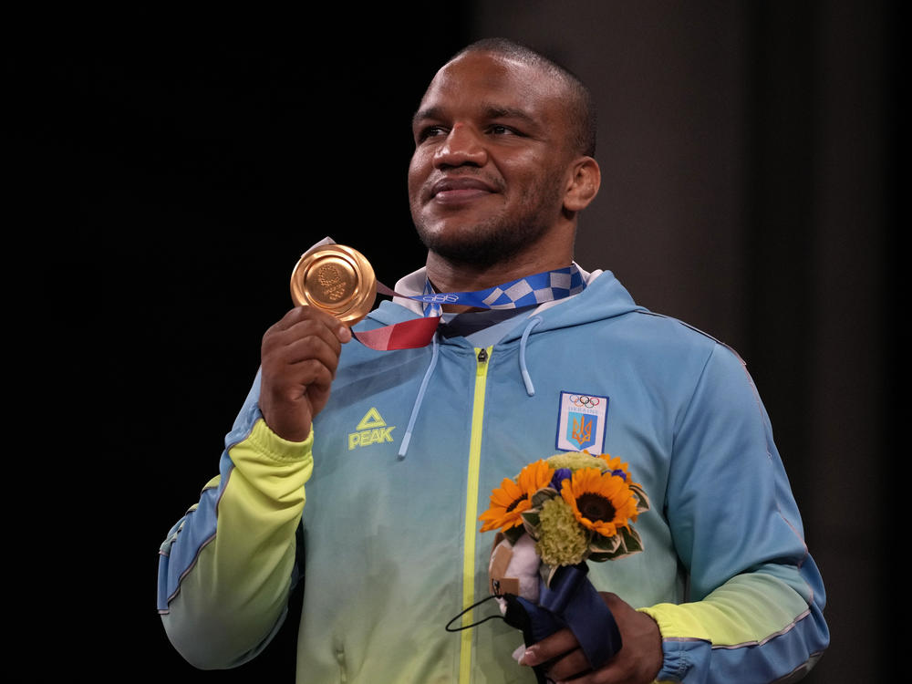 Gold medalist Zhan Beleniuk of Ukraine celebrates on the podium during the medal ceremony for men's 87-kilogram Greco-Roman wrestling.