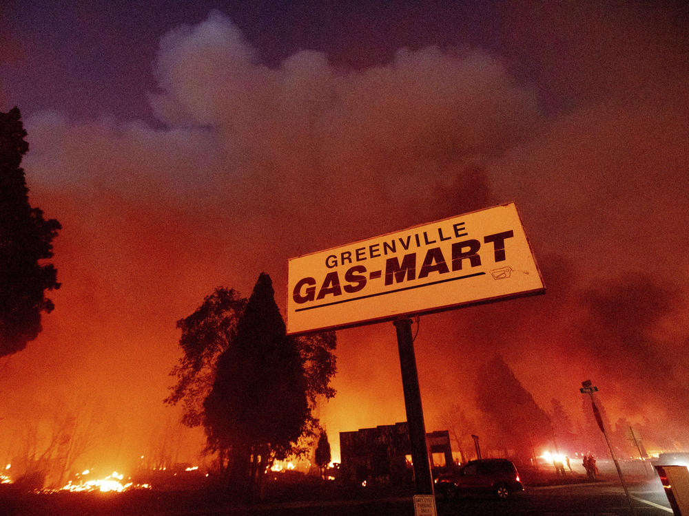 Flames consume buildings as the Dixie Fire tears through the Greenville community of Plumas County, Calif., on Aug. 4, 2021.