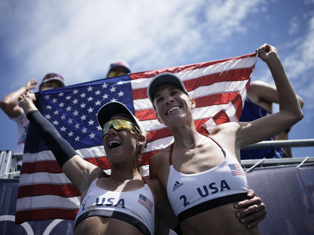 U.S. beach volleyball pair April Ross (left) and Alix Klineman celebrate winning a women's beach volleyball gold medal in a match against Australia at the Summer Olympics in Tokyo.