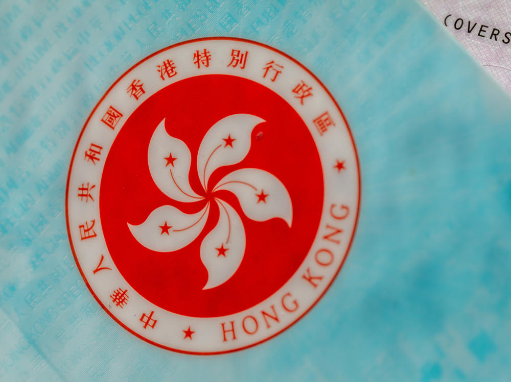 The Hong Kong Special Administrative Region (HKSAR) emblem on a page of the HKSAR passport arranged in Hong Kong, China, earlier this year. The Biden administration says it will allow Hong Kong residents to remain and work in the U.S. for at least 18 months without fear of deportation.