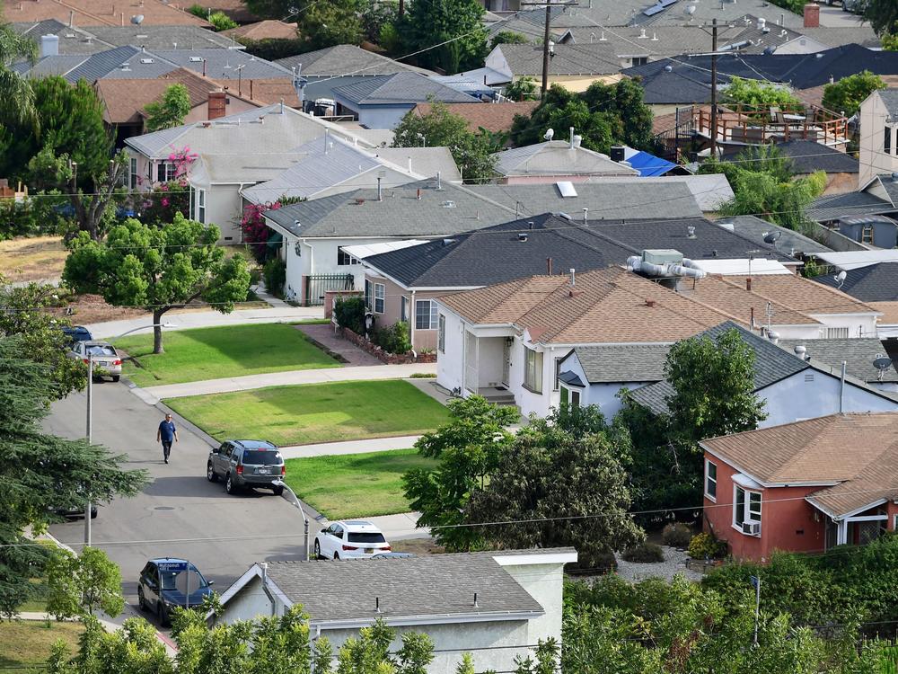 A man walks through a neighborhood of single-family homes in Los Angeles last week. The CDC announced a new temporary eviction ban a few days after the previous one expired.