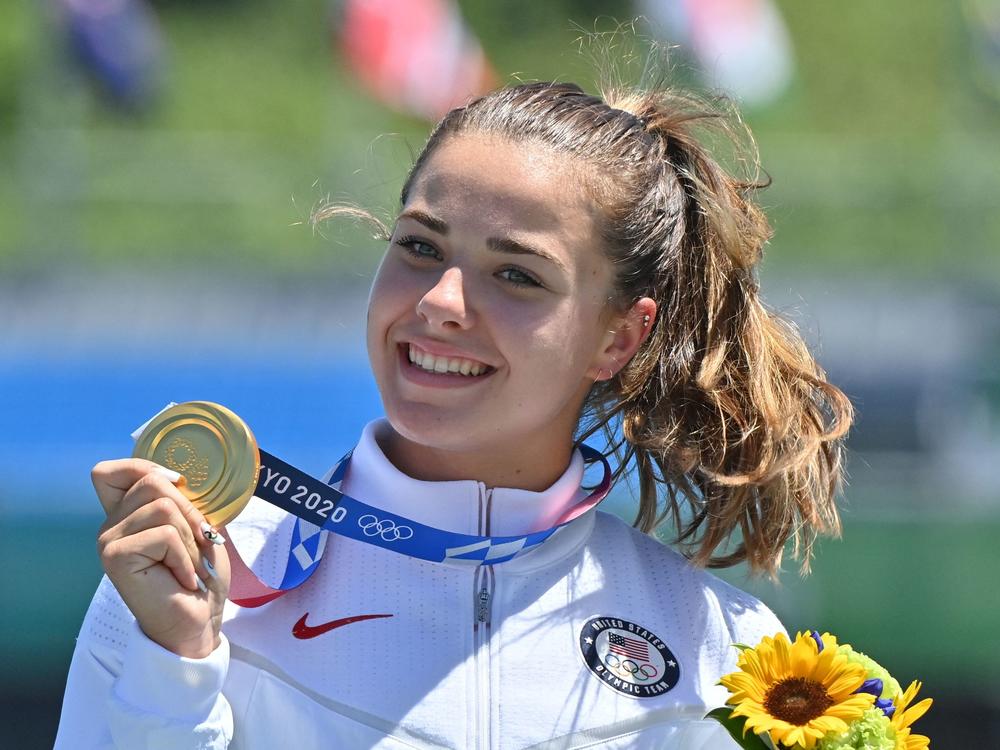 American Nevin Harrison holds up her gold medal on the podium following the women's canoe single 200-meter final.