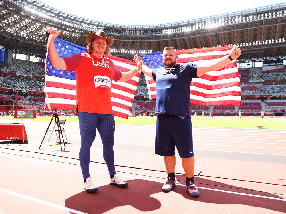 Gold medalist Ryan Crouser (L) and silver medalist Joe Kovacs of Team United States celebrate after competing in the Men's Shot Put Final on Thursday at the Tokyo 2020 Olympic Games.