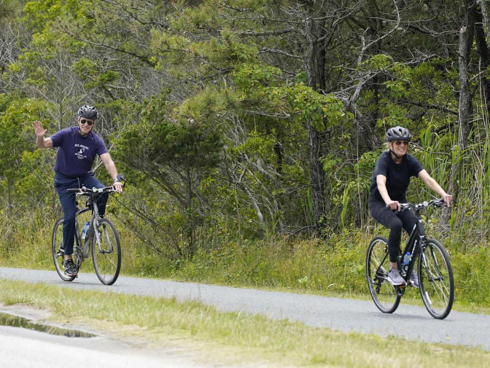 President Biden rides his bike in Rehoboth Beach, Del., earlier this year with first lady Jill Biden. The family has a beach house nearby.