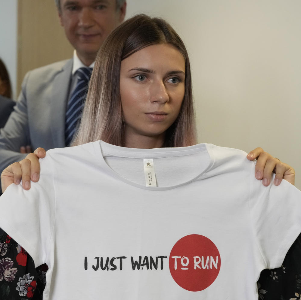 Belarusian sprinter Kristina Timanovskaya displays an Olympic-related T-shirt with the slogan 