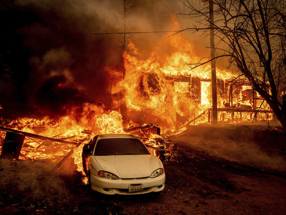 Flames from the Dixie Fire consume a home on Highway 89 south of Greenville, Calif., on Thursday.